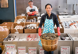 Proud Vietnamese couple working in an American fish market